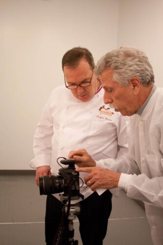 Chef Jacques Torres receives photography tips from Battman. Photo by Kara Chin.