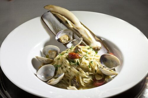 Home-made linguine with razor clams, manila clams, cherry tomatoes and parsley