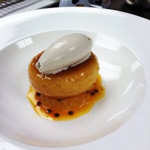 Rum baba, tropical fruit salad, passion fruit glaze, rum barrilito tres estrellas, black sesame ice cream by Chef Juan Cuevas