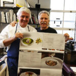 Battman and Chef Jean Louis Dumonet review the press sheets for Master Chefs of France cookbook.