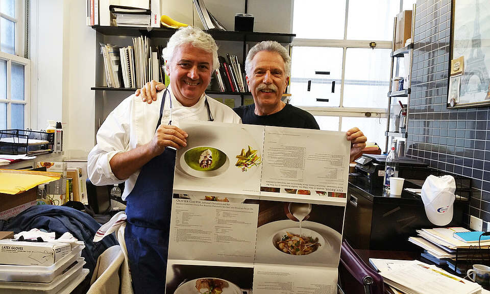 Battman and Chef Jean Louis Dumonet review the press sheets for Master Chefs of France cookbook.