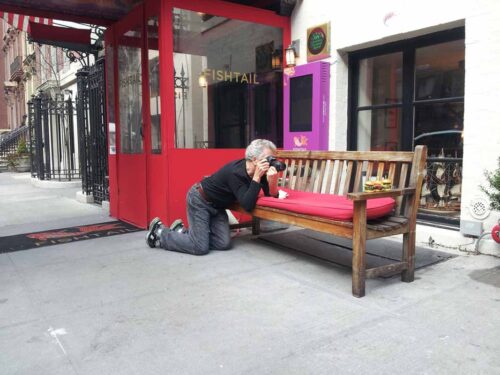 Battman taking pictures outside of Fishtail restaurant in NYC for the Street Eats book.