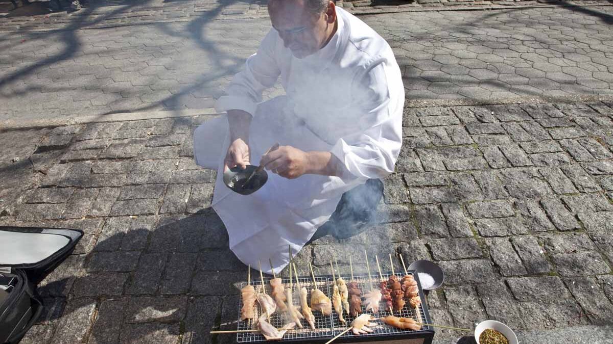 Chef Jean-George Vongerichten cooking on the sidewalk in NYC for the Street Eats book. Photo by Battman.