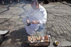 Chef Jean-George Vongerichten cooking on the sidewalk in NYC for the Street Eats book. Photo by Battman.