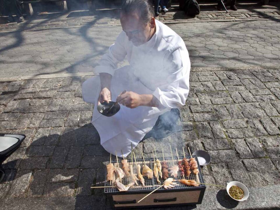 Chef Jean-George Vongerichten cooking on the sidewalk in NYC for the Street Eats book. Photo by Battman.