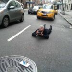 Battman lying in the street taking pictures for the Street Eats book.